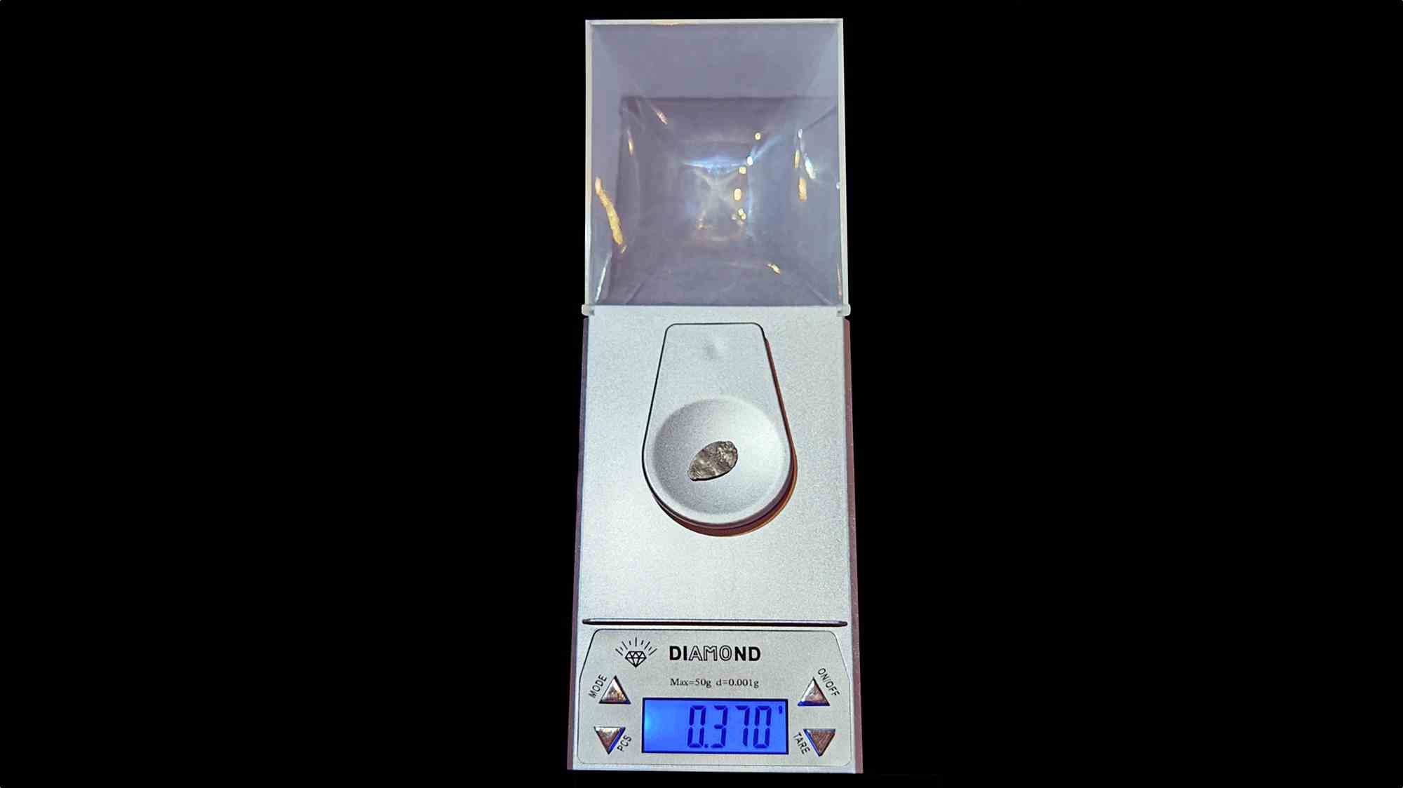 Цифровые весы для ювелирных изделий DIAMOND с защитным колпаком, на чаше лежит камень, на дисплее — 0.370 г, максимальная нагрузка 50 г, шаг 0.001 г.
